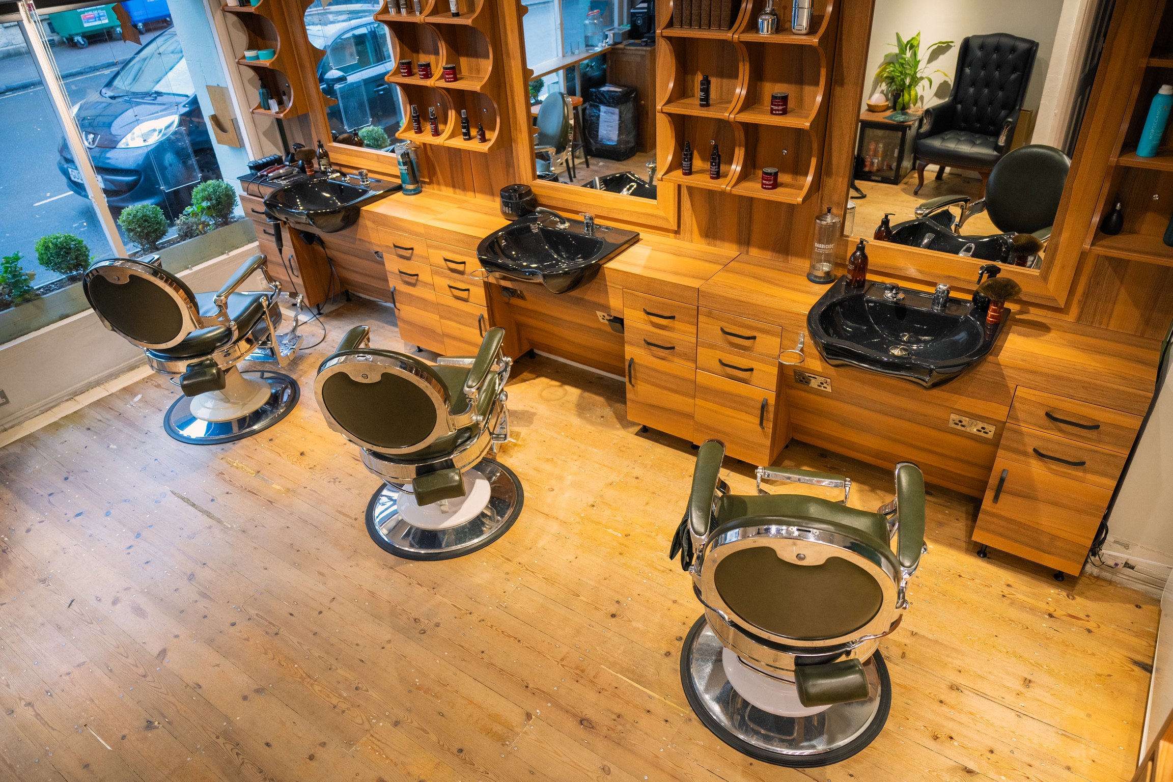 Le Barbier interior with barber chairs and wooden workstations in Bath